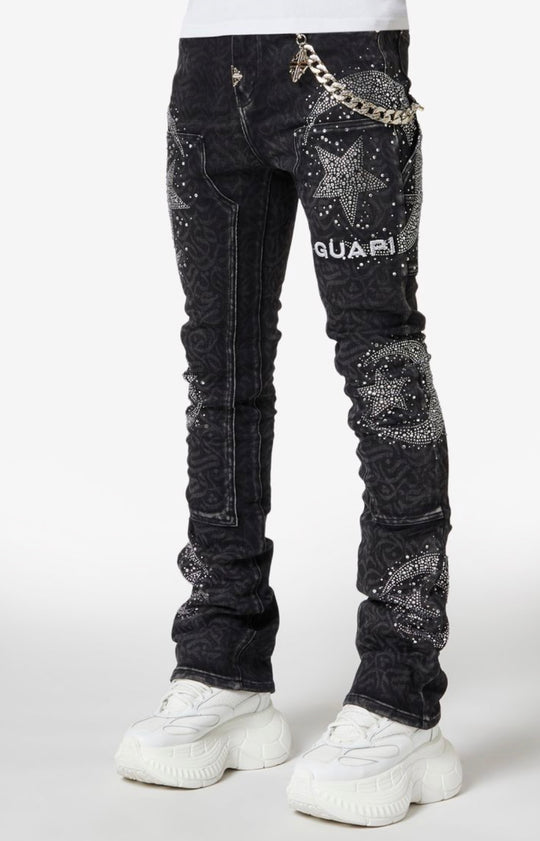 Black distressed jeans with silver embellishments and 'GUAPII' branding on a white background