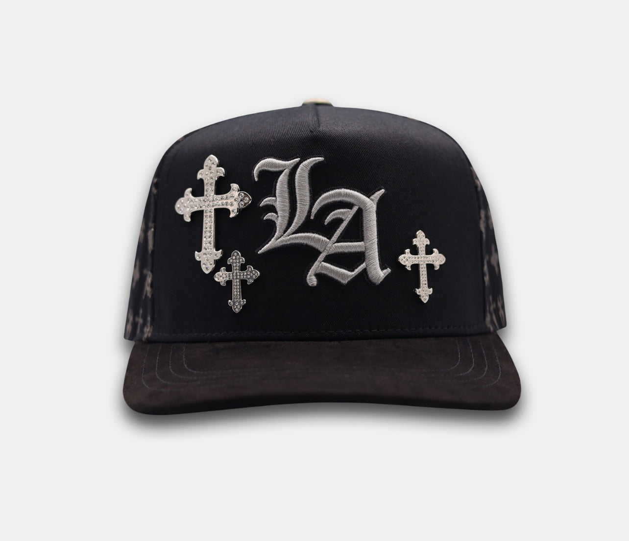 Black cap with 'LA' and cross designs on a white background