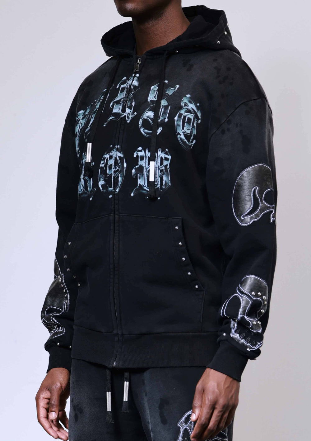 Black hoodie with white graphic designs on a plain background