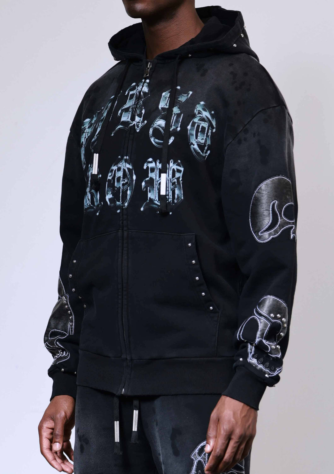 Black hoodie with white graphic designs on a plain background