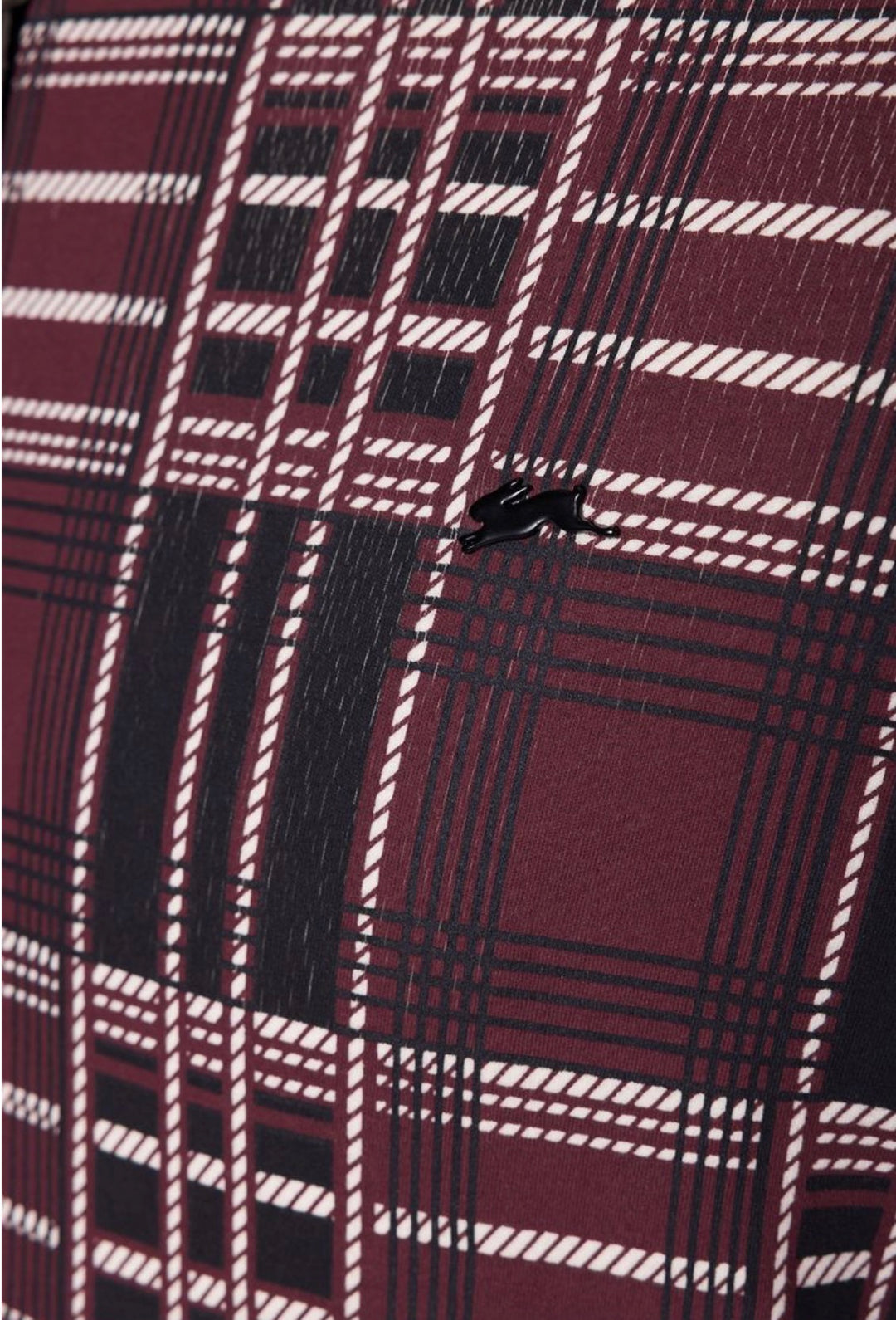 Close-up of a plaid fabric with red, black, and white pattern