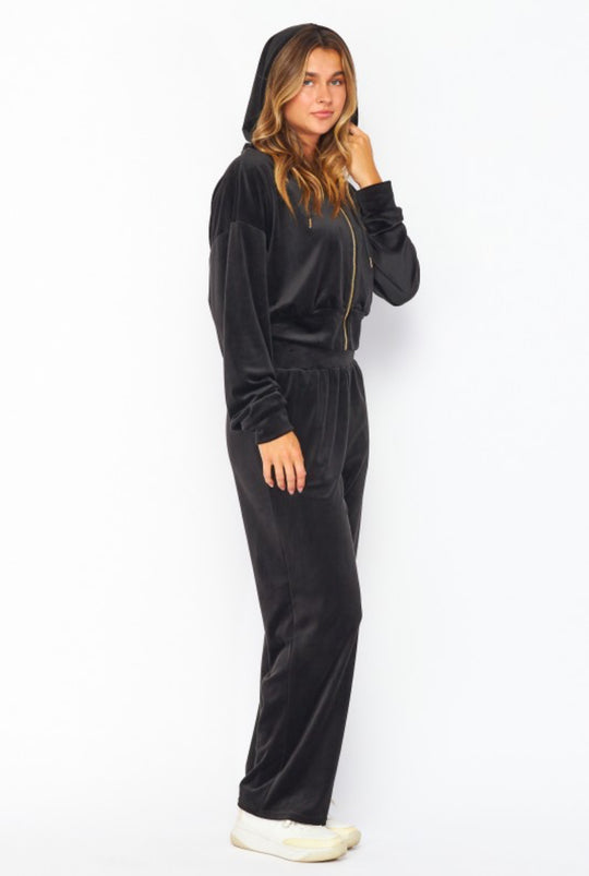 Woman wearing a black onesie on a white background