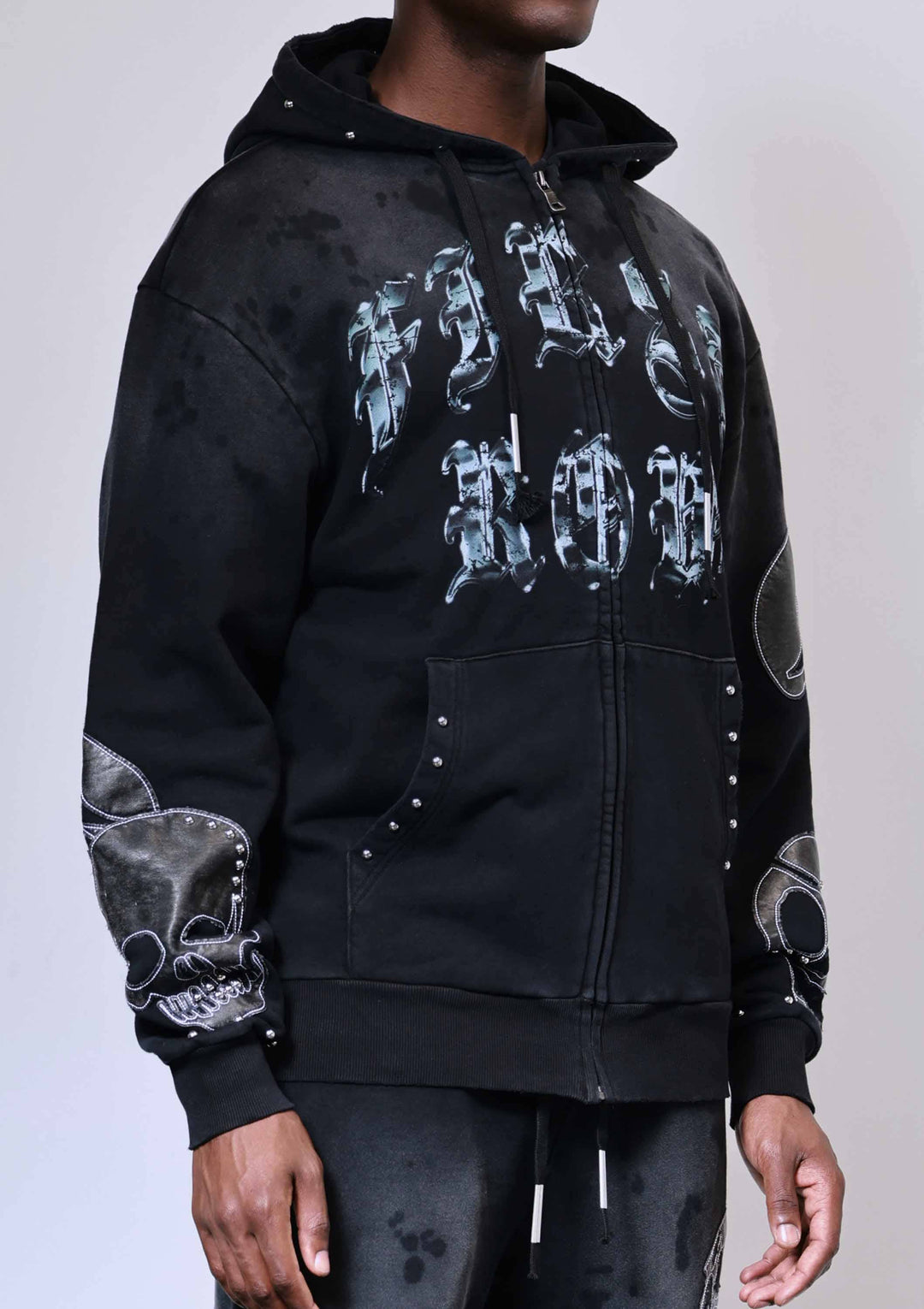 Black hoodie with white graphic designs on a plain background