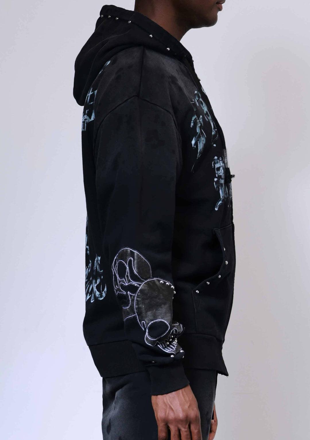 Black hoodie with white graphic designs on a plain background