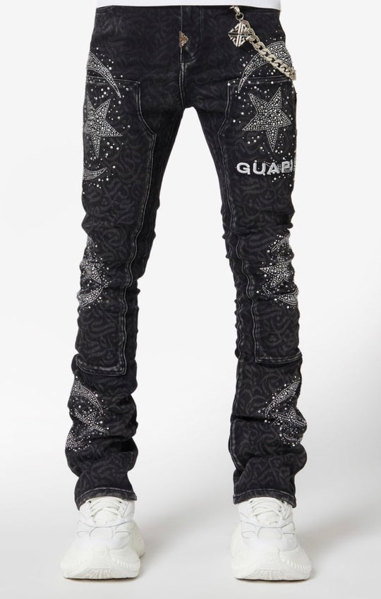 Black jeans with star patterns and branding on a white background