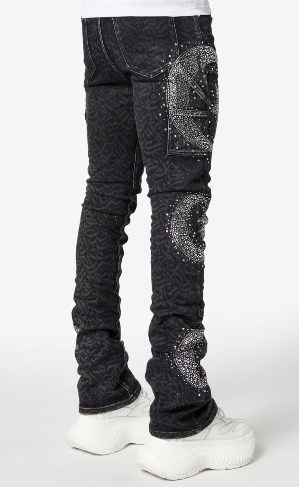 Black jeans with silver embellishments worn by a person on a white background