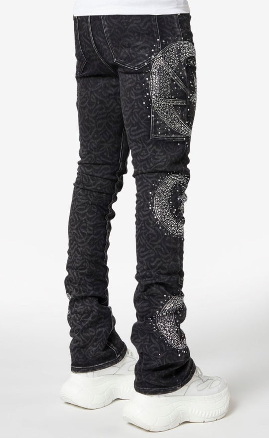 Black jeans with silver embellishments worn by a person on a white background